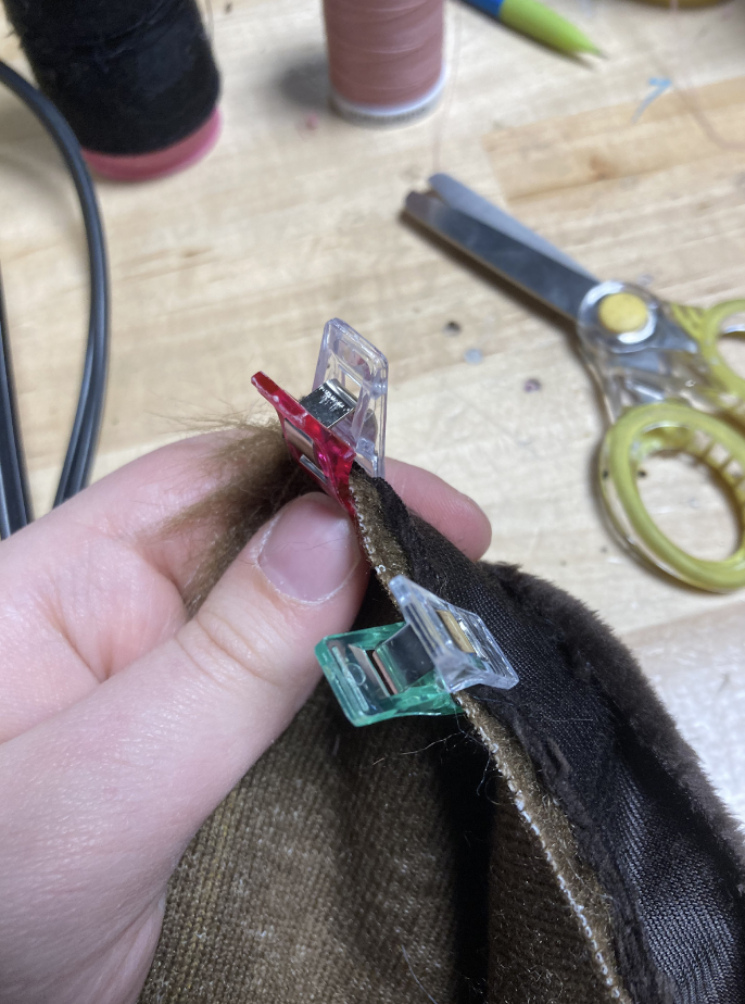 A strip of minky clipped to the opening edge of the handpaw.